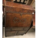 A studded brown leather covered bureau in the Spanish or Portugese taste,