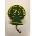 A reproduction painted metal John Deere wall mounted bell