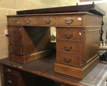 A modern mahogany double pedestal desk, the top with tooled and gilded leather insert,