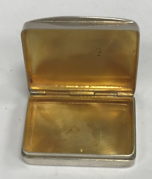 A 20th Century silver "castle top" pill box of rectangular form with gilt-washed interior (by S J