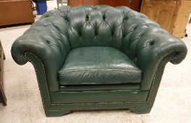 A pair of green buttoned leather upholstered scroll arm chairs with studded show frame front on