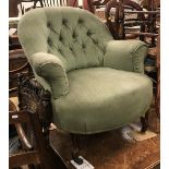 A Victorian buttoned upholstered scroll arm salon chair on moulded cabriole front legs to castors