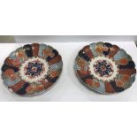 A pair of early 20th Century Japanese Imari scallop edged chargers,