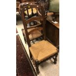 A 17th Century and later walnut ladder back rush seat chair,