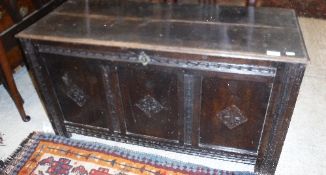 A 17th Century oak coffer, the panelled top above three panel sides,