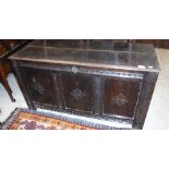 A 17th Century oak coffer, the panelled top above three panel sides,