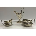 A late Victorian silver cream jug of inverted helmet form,
