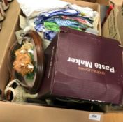 Two boxes of sundry items to include decorative china wares, assorted table linens, etc.