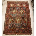 A Caucasian rug, the central panel set with floral design on a dark blue ground,