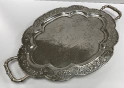 A circa 1900 Chinese silver shaped oval tray with central inscription "CEG" within an oval,