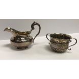 A William IV silver cream jug of bellied form with acanthus thumbpiece to the C scroll handle,