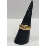 An 18 carat gold dress ring set with central single diamond, approx 0.1 carat, size M, 5.
