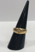 An 18 carat gold dress ring set with central single diamond, approx 0.1 carat, size M, 5.