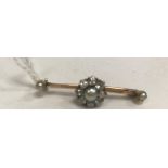 An un-marked yellow metal brooch set with flower head design of central pearl, approx size 3,