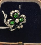 A Victorian diamond and peridot set "clover" brooch, the centre stone approx 0.15 carat, 2 cm x 1.