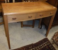 An Arts & Crafts style side table, the plain top above two drawers,