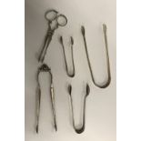 Three pairs of sugar tongs various sizes, dates and makers,