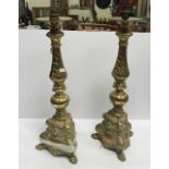 A pair of brass table lamps in the Baroque style,