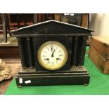 A black slate mantel clock, the white dial set with Roman numerals, 31 cm long x 26.