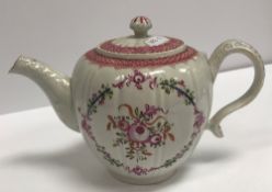An 18th Century Pearlware squash shaped teapot with floral spray decoration and foliate moulded