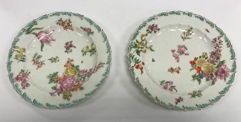 A pair of 18th Century Chelsea dishes with scrolling acanthus rims and central floral spray