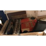 A box containing various LPs and 45s, together with a Canon Canonet 8 cine camera,