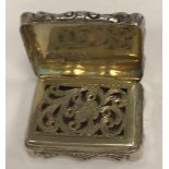 A Victorian silver foliate engraved vinaigrette of shaped rectangular form with waisted sides,