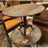 A 19th Century oak tea table, the circular snap top on a turned pedestal to cabriole tripod base,