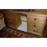 A modern pine dressing chest with mirrored superstructure over a kneehole flanked by two banks of