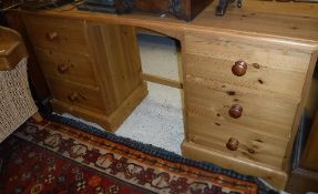 A modern pine dressing chest with mirrored superstructure over a kneehole flanked by two banks of