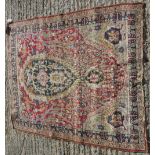 A Kirman prayer rug, the central panel set with foliate decorated medallion on a red ground,