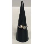 A ladies platinum set crossover diamond ring, each stone approx 0.25 carat, size N, 2.