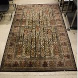 A Persian rug, the central panel set with tiled design, each with stylised floral decoration,