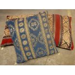 Three large Caucasian Kelim cushions, two in red and gold, the other blue and gold,