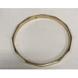 A 9 carat gold bangle of dodecagon form with Greek key design, 6.9 cm inner diameter, 8.