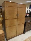 A 1930's oak and walnut banded three piece bedroom suite comprising two door wardrobe,