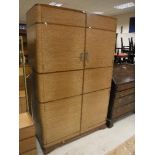 A 1930's oak and walnut banded three piece bedroom suite comprising two door wardrobe,