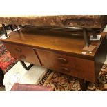 A 1960's teak dressing chest with mirrored back over a bank of four drawers with solid navette