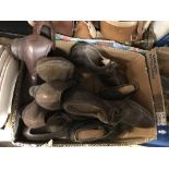 A box containing assorted vintage leather shoes,