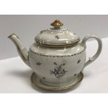 A circa 1800 monochrome and gilt decorated teapot and cover on stand,