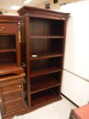 A modern mahogany side unit, the plain top above two drawers above two enclosed shelves,