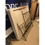 A modern Victorian style double bedstead of rail form together with cotton covered striped bed base,