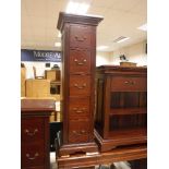 A pair of modern mahogany five drawer column style chests,