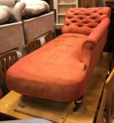A Victorian buttoned upholstered chaise lounge on turned tapering legs to brass caps and china