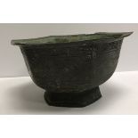 A Chinese bronze hexagonal bowl, the side panels decorated with lions amongst trees,