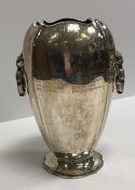 A George IV silver trophy cup of elongated squash form with two swing handles,