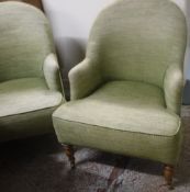 A pair of modern tub chairs with lime green upholstery,