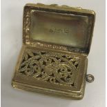 An early Victorian silver gilt vinaigrette with engine-turned and relief work scrolling foliate
