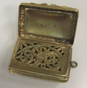 An early Victorian silver gilt vinaigrette with engine-turned and relief work scrolling foliate