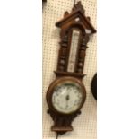 A late Victorian oak framed aneroid barometer thermometer with alcohol thermometer,